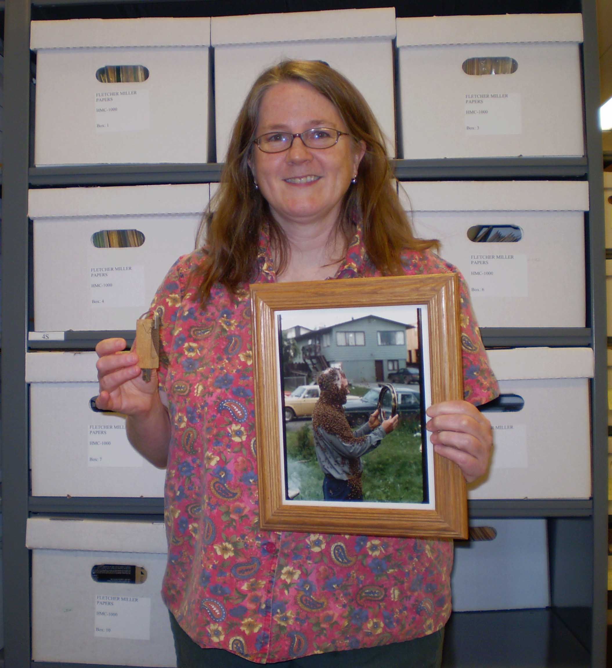 Sigrid Brudie holding queen cage and a portrait of Fletcher Miller with a "bee beard."